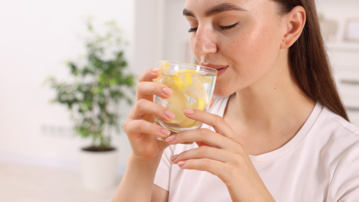 Frau trinkt Zitronenwasser © Shutterstock