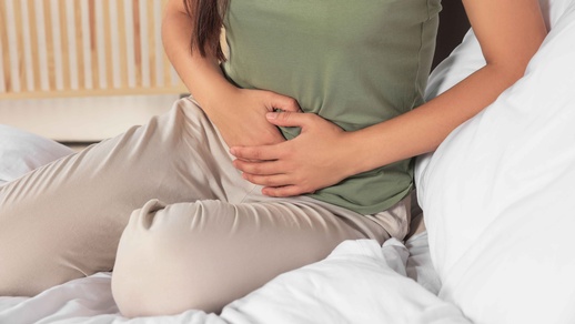 Frau hält sich schmerzenden Bauch © Shutterstock