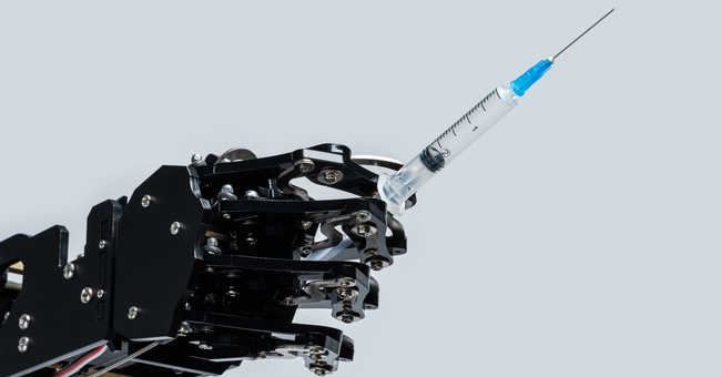 Roboter mit Spritze in der künstlichen Hand © Shutterstock